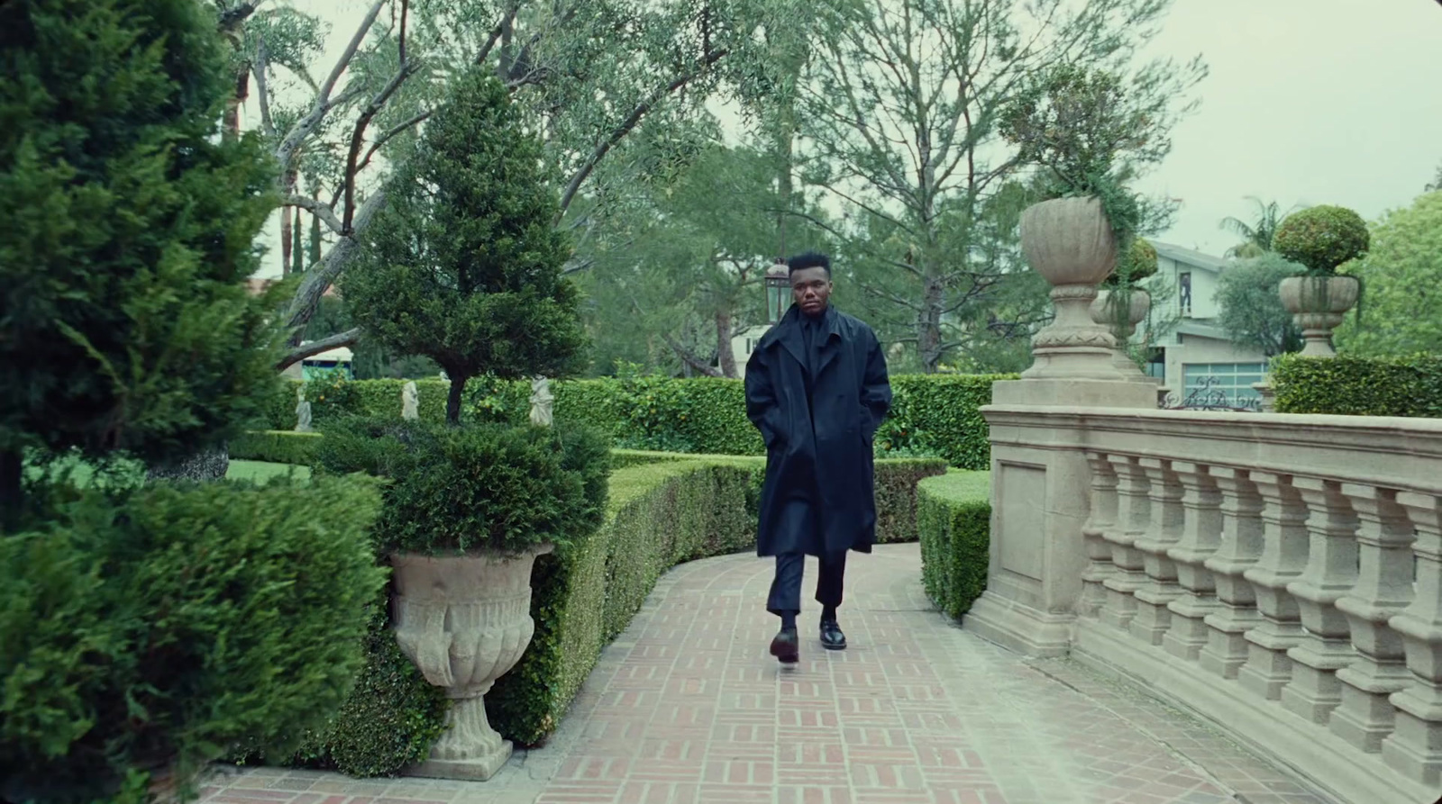 a man is walking down a brick walkway