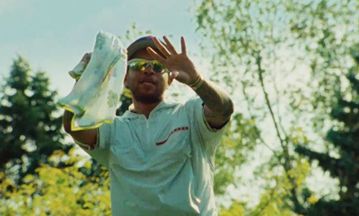 a man holding a white frisbee in his right hand