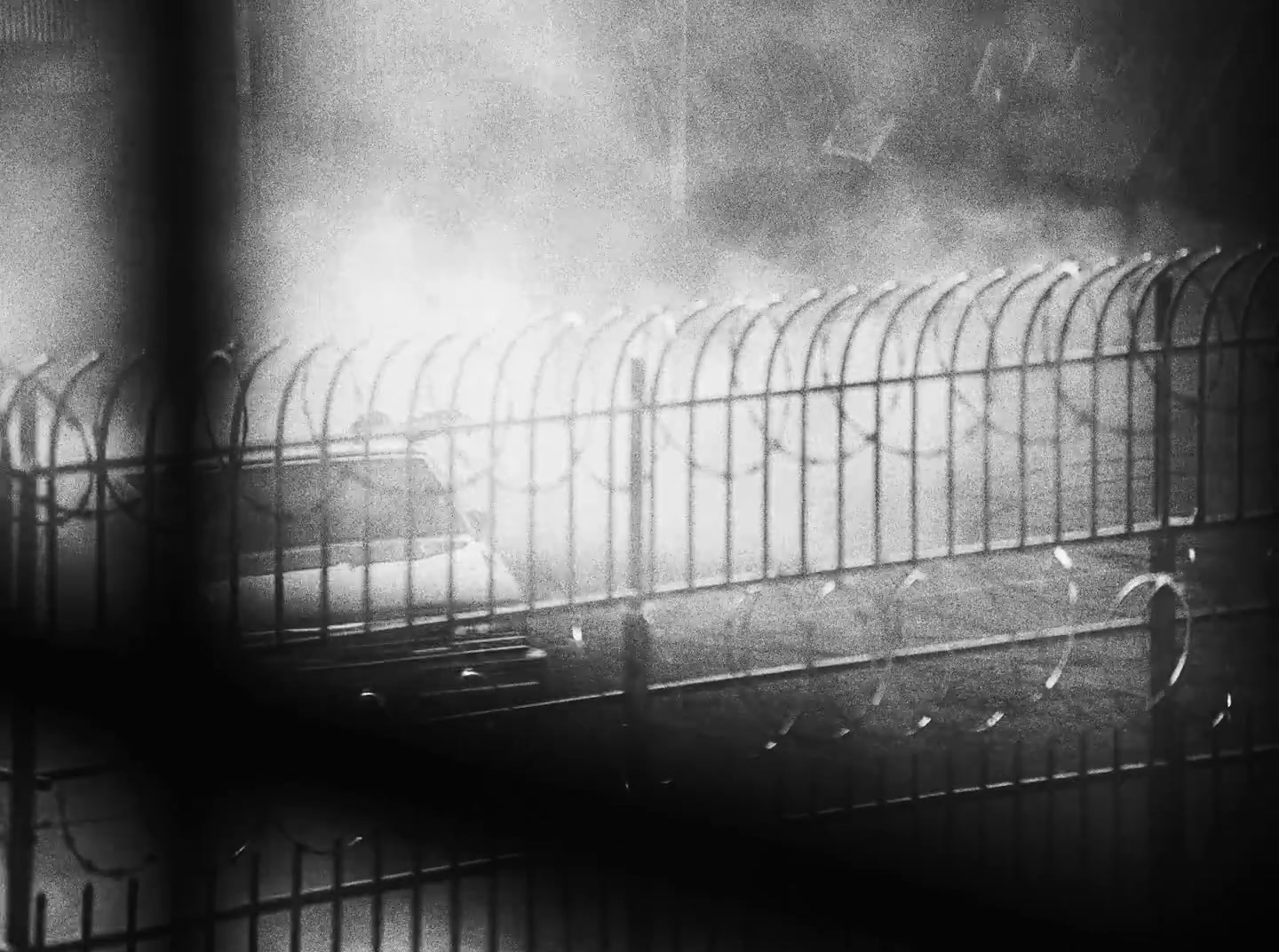 a black and white photo of a jail cell