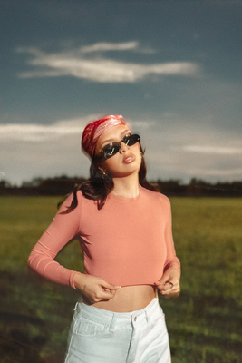 a woman wearing sunglasses and a pink shirt