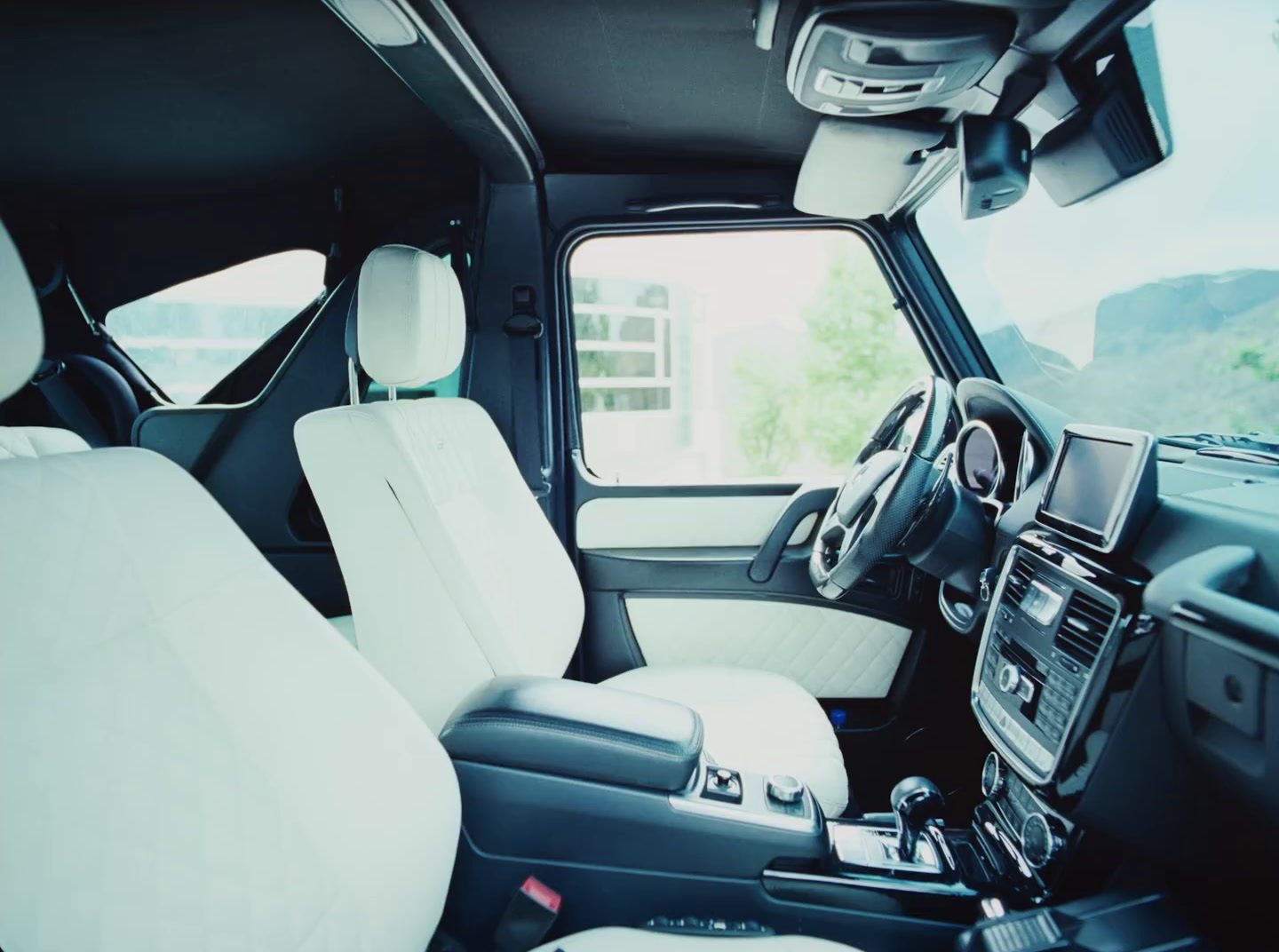 the interior of a vehicle with white leather seats