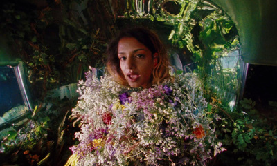 a woman holding a bunch of flowers in her hands