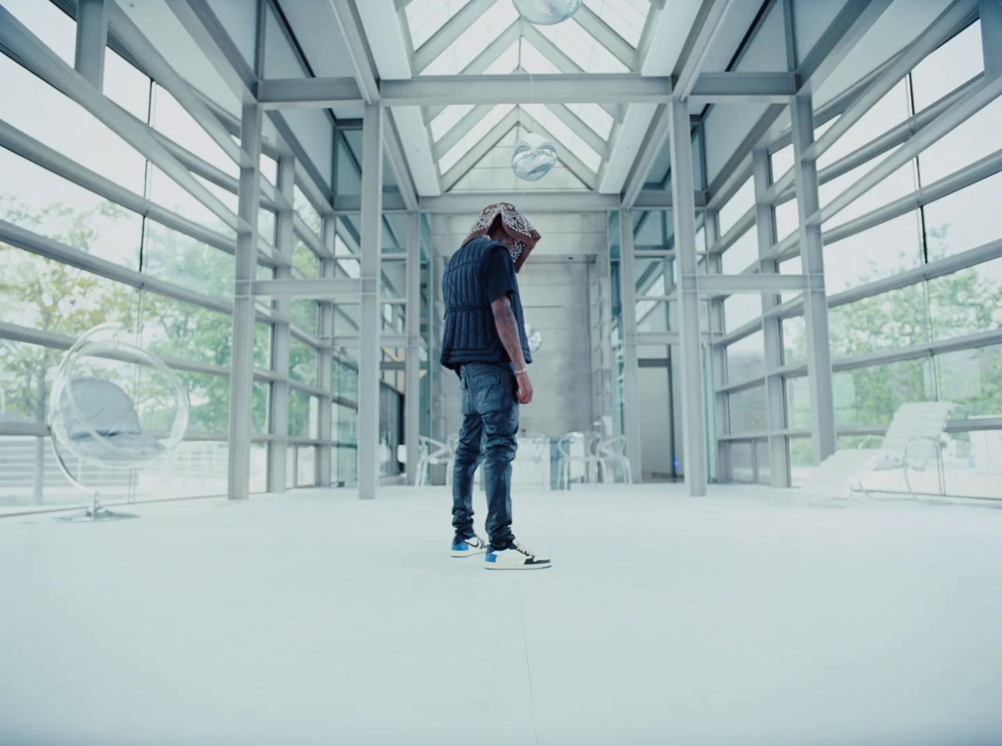 a man standing in a room with a skateboard