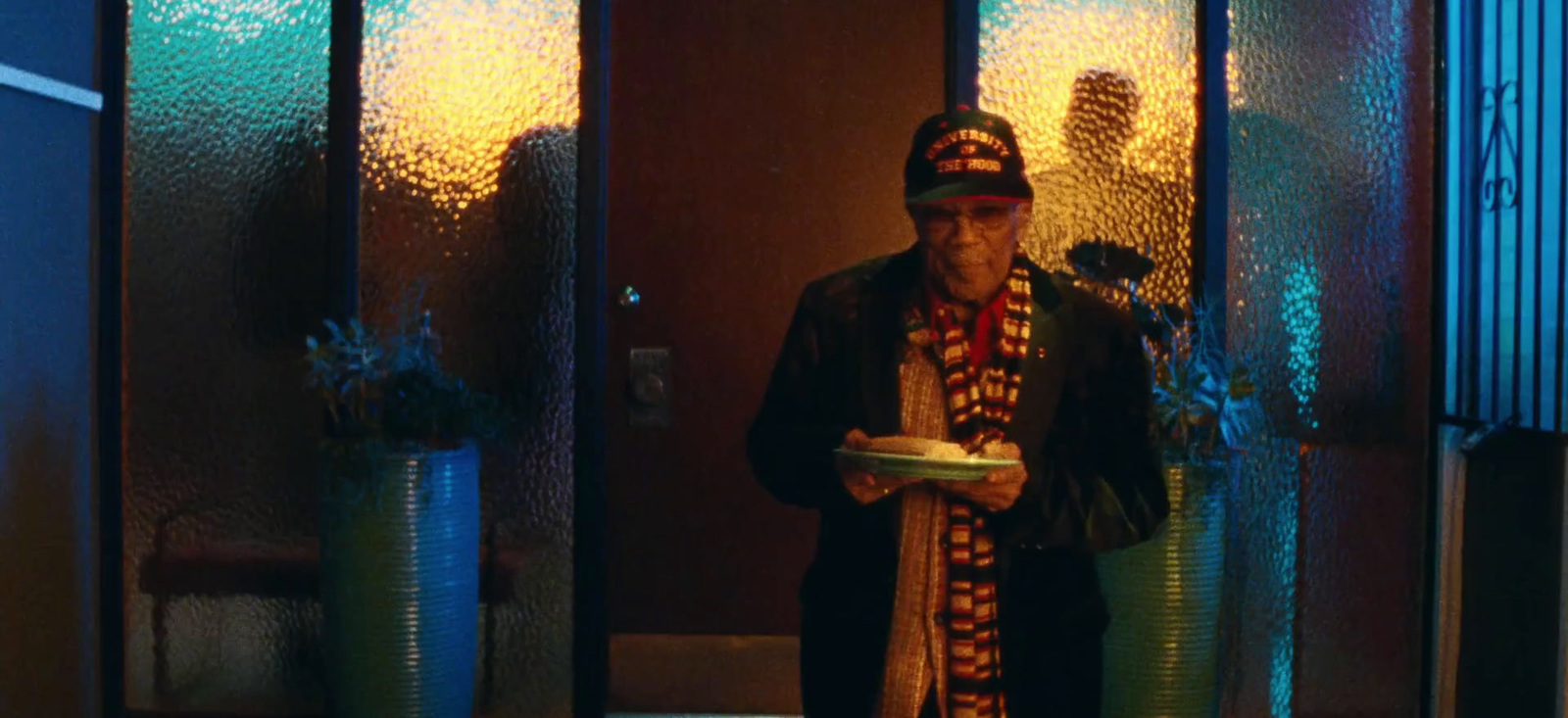 a man standing in front of a glass door