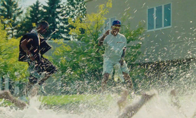 a couple of men riding water skis on top of a body of water