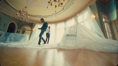 a man standing on a wooden floor in a room