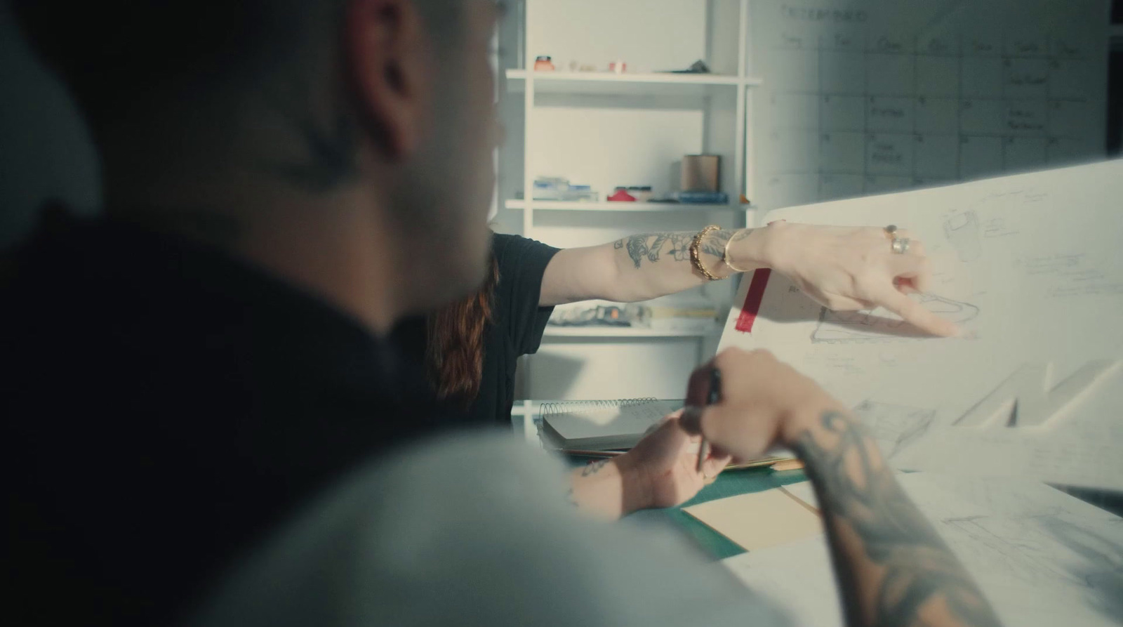 a man and a woman looking at a piece of paper