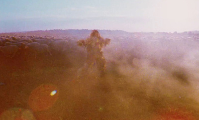 a blurry image of a person walking through a field