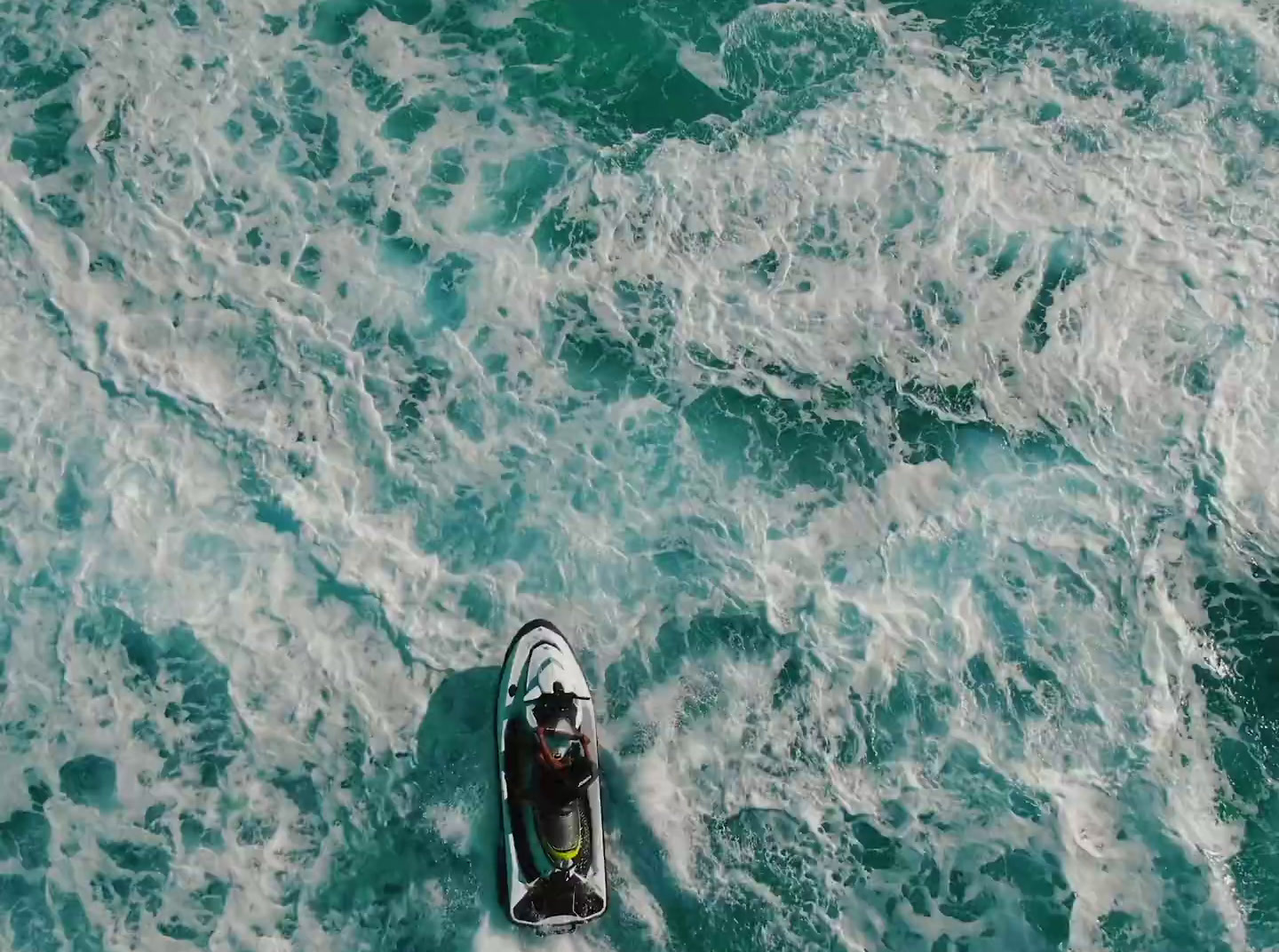 a small boat floating on top of a body of water