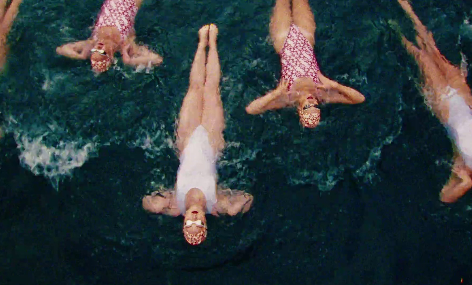 a group of people floating on top of a body of water