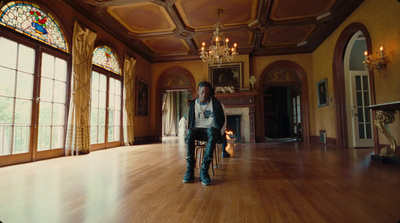 a woman sitting on a chair in a large room