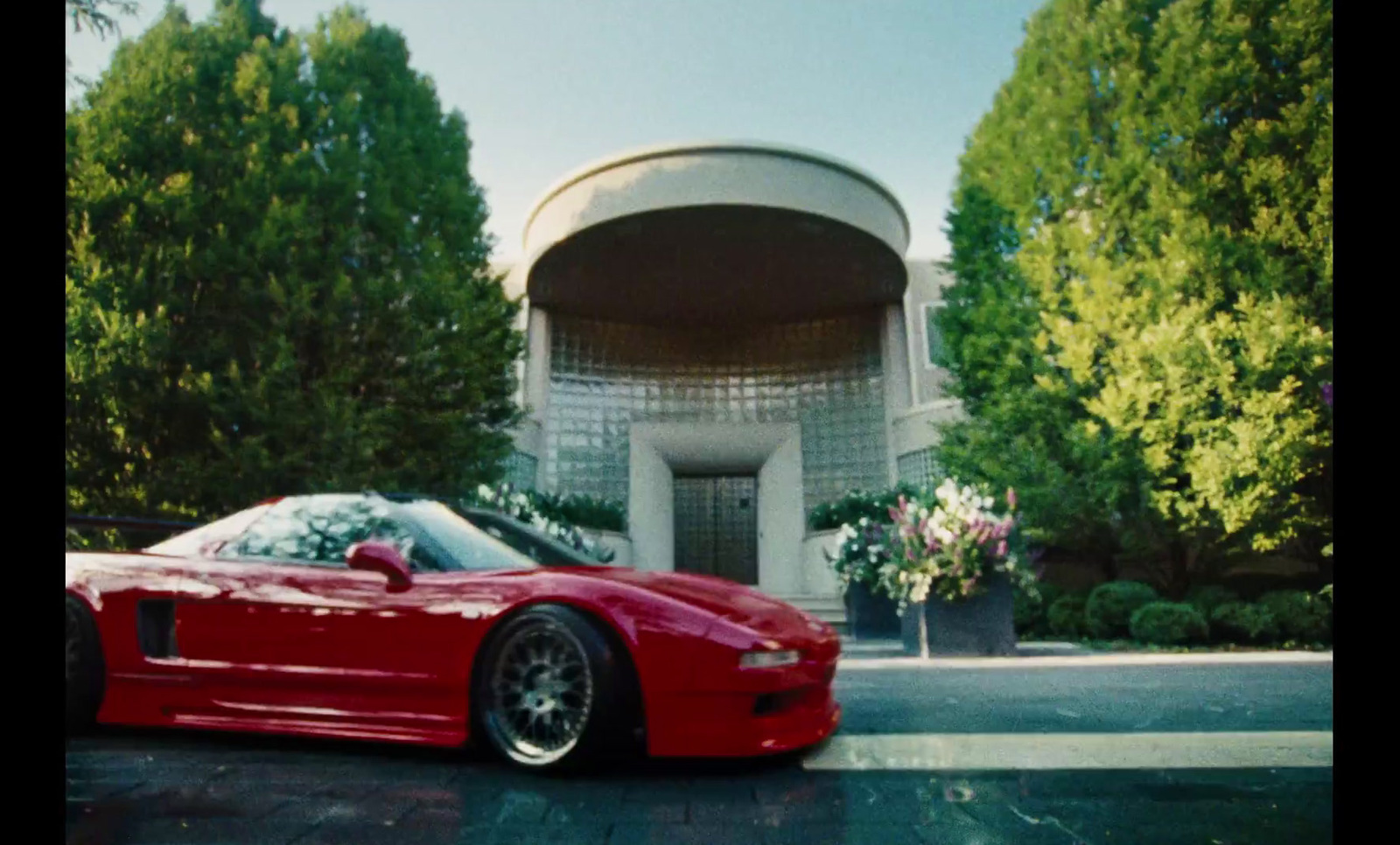 a red sports car parked in front of a building