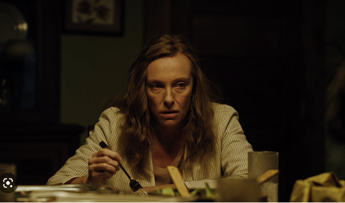 a woman sitting at a table with a knife and fork in her hand