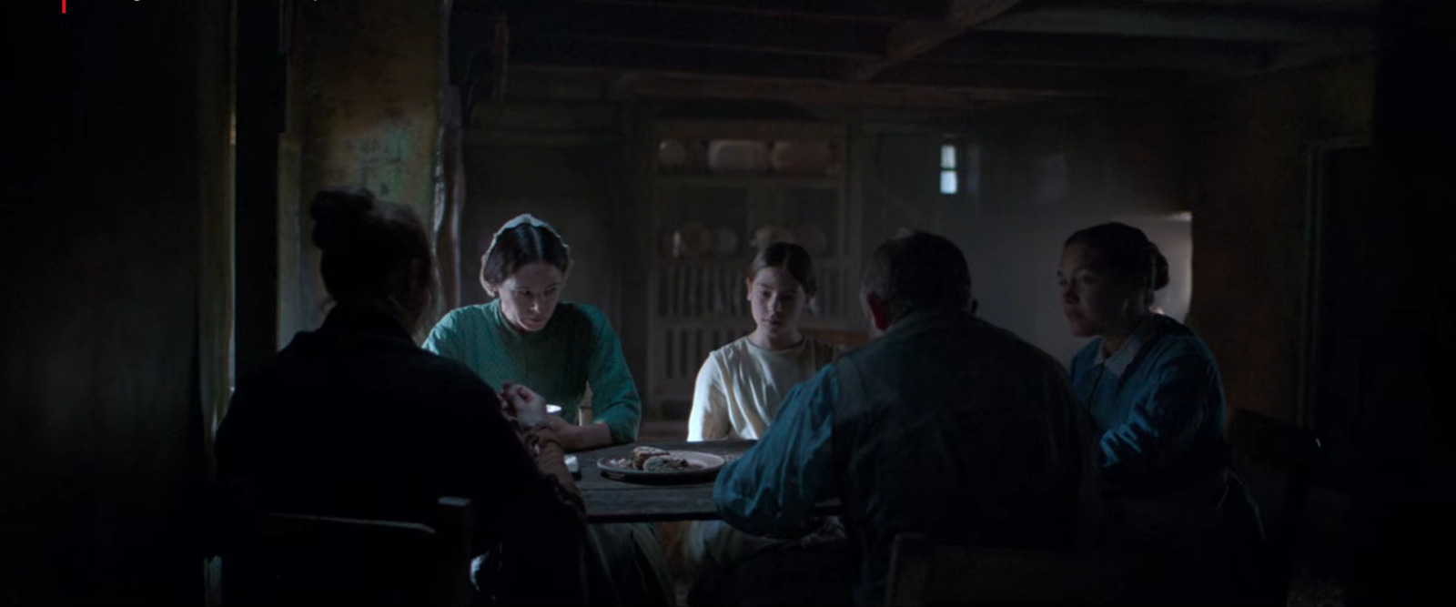 a group of people sitting around a table