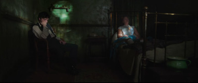 a man and a woman sitting in a dimly lit room