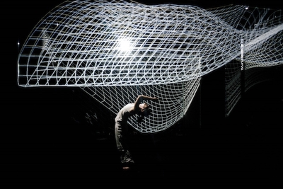 a man standing in front of a white net