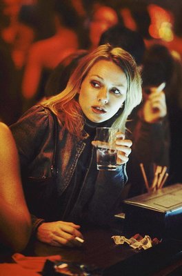 a woman sitting at a table with a glass of water