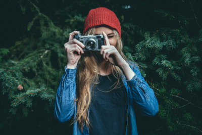 a woman taking a picture with a camera