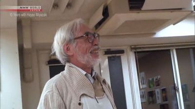 a man with a beard and glasses standing in a room