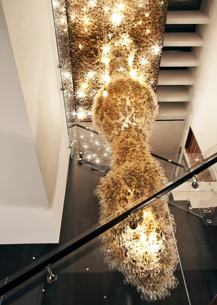 a staircase with a bunch of lights hanging from the ceiling