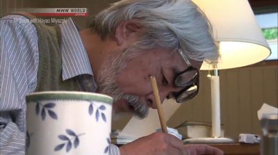 a man with glasses is painting a vase with a brush