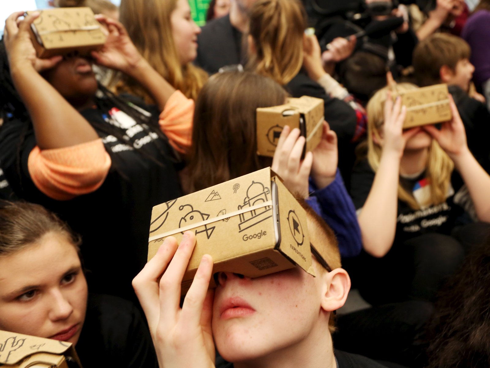 a group of people with cardboard boxes on their heads