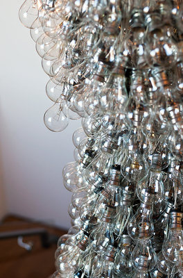 a bunch of wine glasses hanging from a ceiling