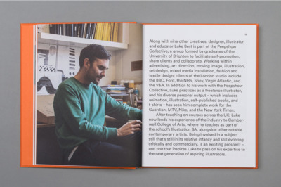 a man sitting in a chair looking at a book