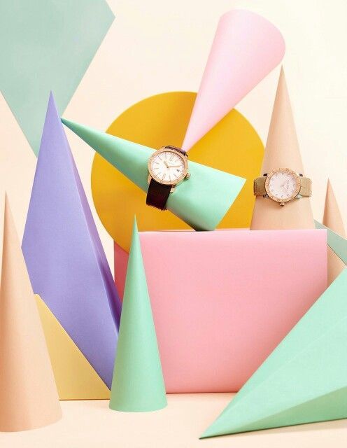 a couple of watches sitting on top of a pile of paper