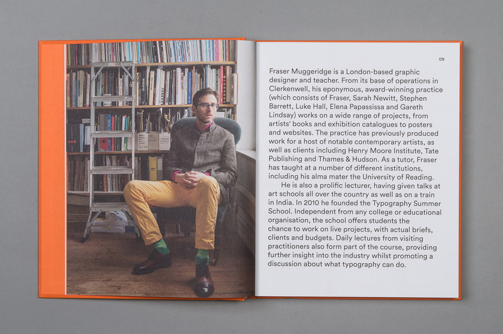 a man sitting in a chair in front of a bookshelf