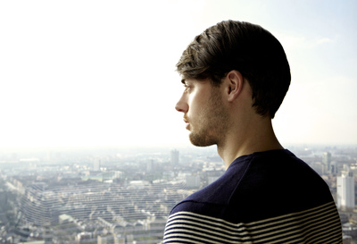 a man standing in front of a cityscape