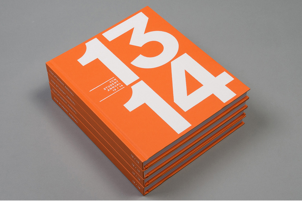 a stack of orange books with white numbers on them