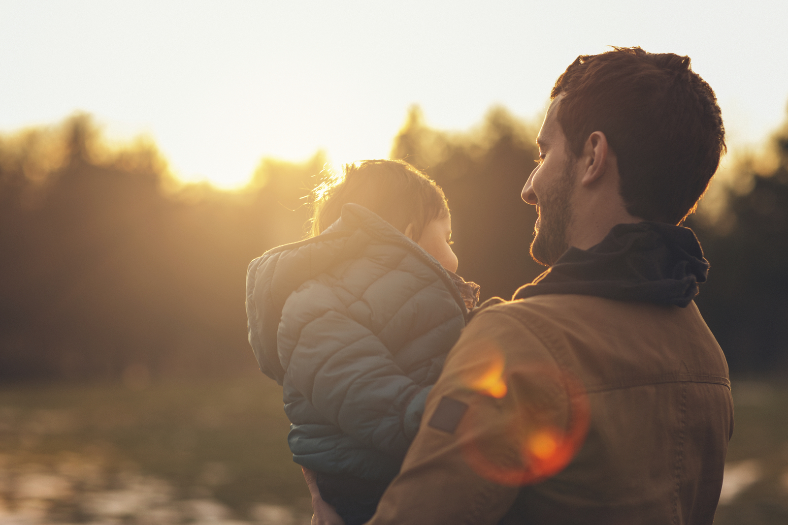 a man holding a little girl in his arms