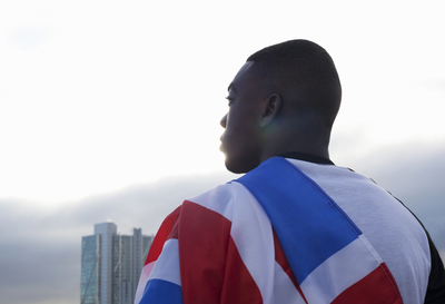 a man with a flag draped around his neck