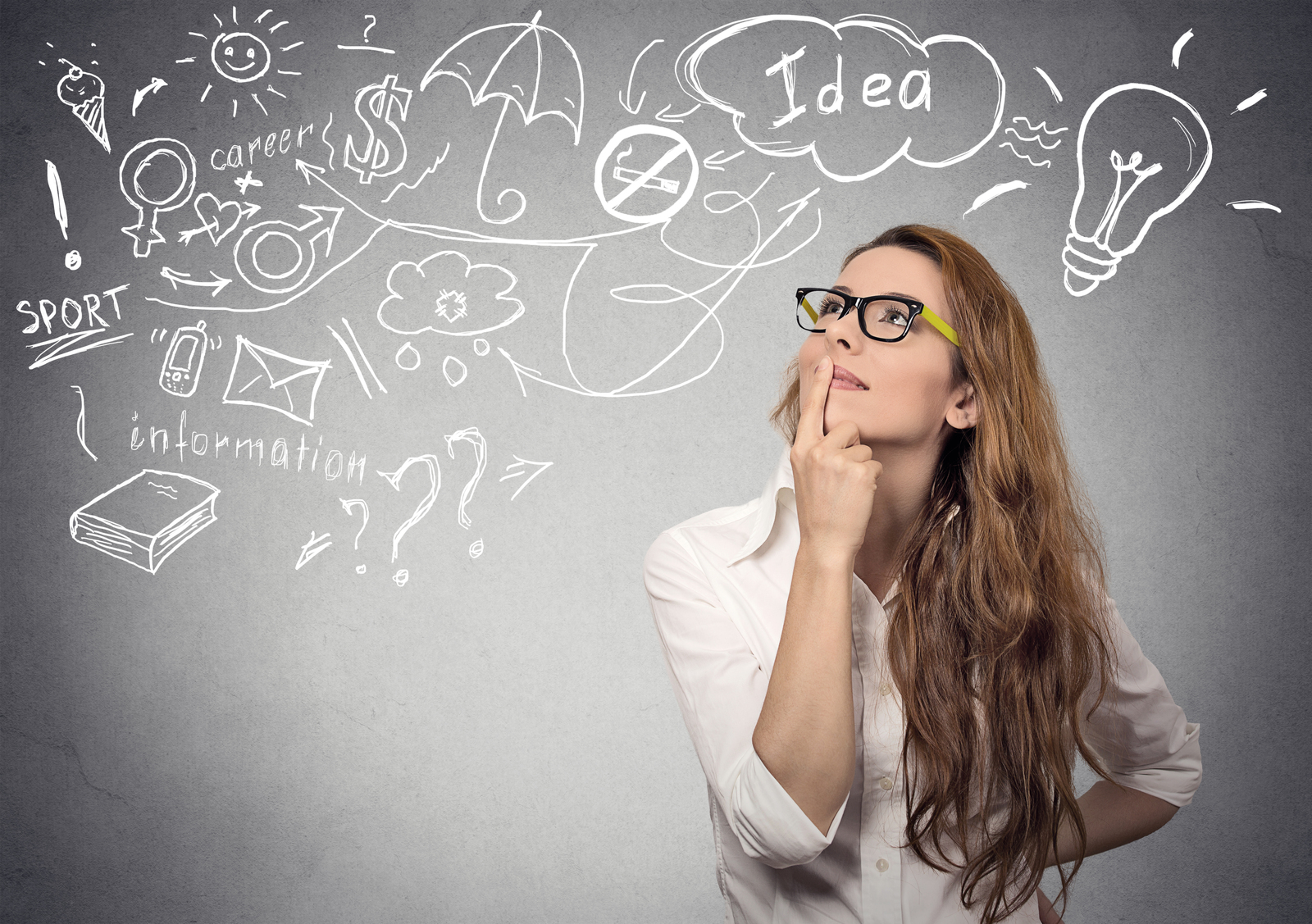 a woman in glasses is looking up at a chalkboard with drawings on it