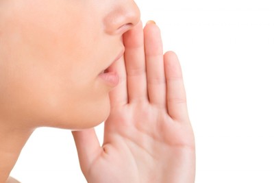 a close up of a person holding their hand up to their face