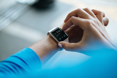 a close up of a person holding a smart watch