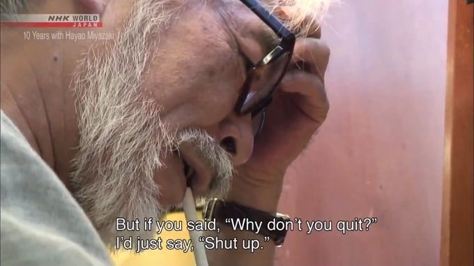 a man with glasses talking on a cell phone