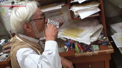 a man in glasses is looking at papers on a desk