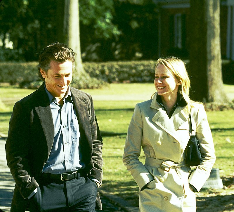 a man and a woman walking in a park