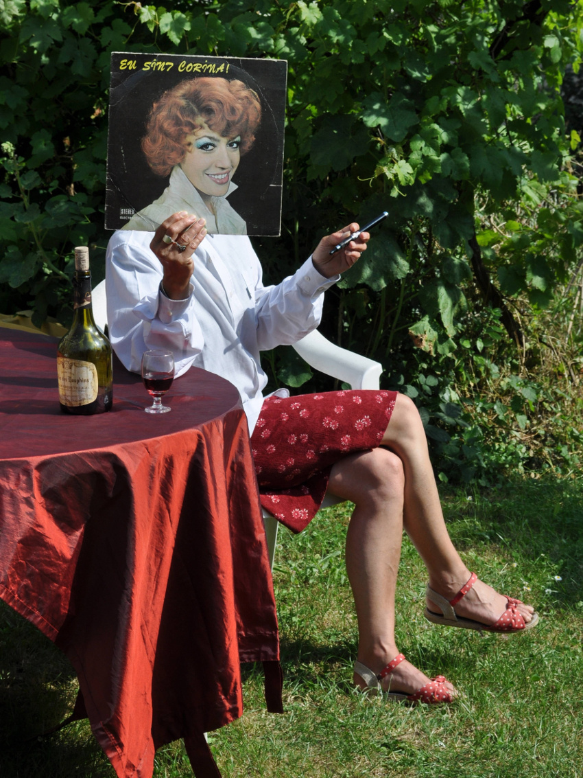 a woman sitting at a table holding a cell phone