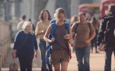 a group of people walking down a sidewalk