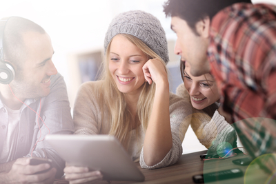 a group of people sitting around a table with headphones on