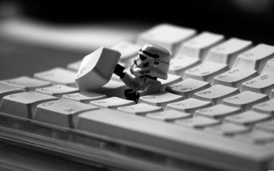 a lego star wars trooper is sitting on a keyboard