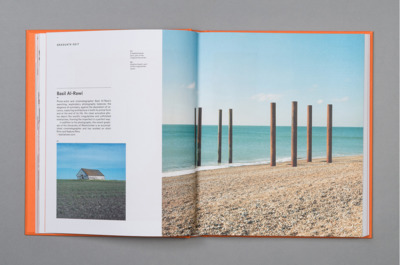 an open book with a picture of a house on the beach