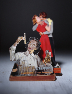 a figurine of a man and a woman holding a bottle