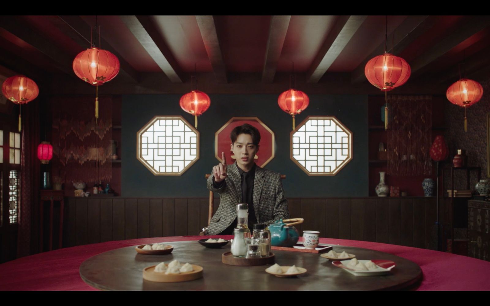 a woman sitting at a table with plates of food