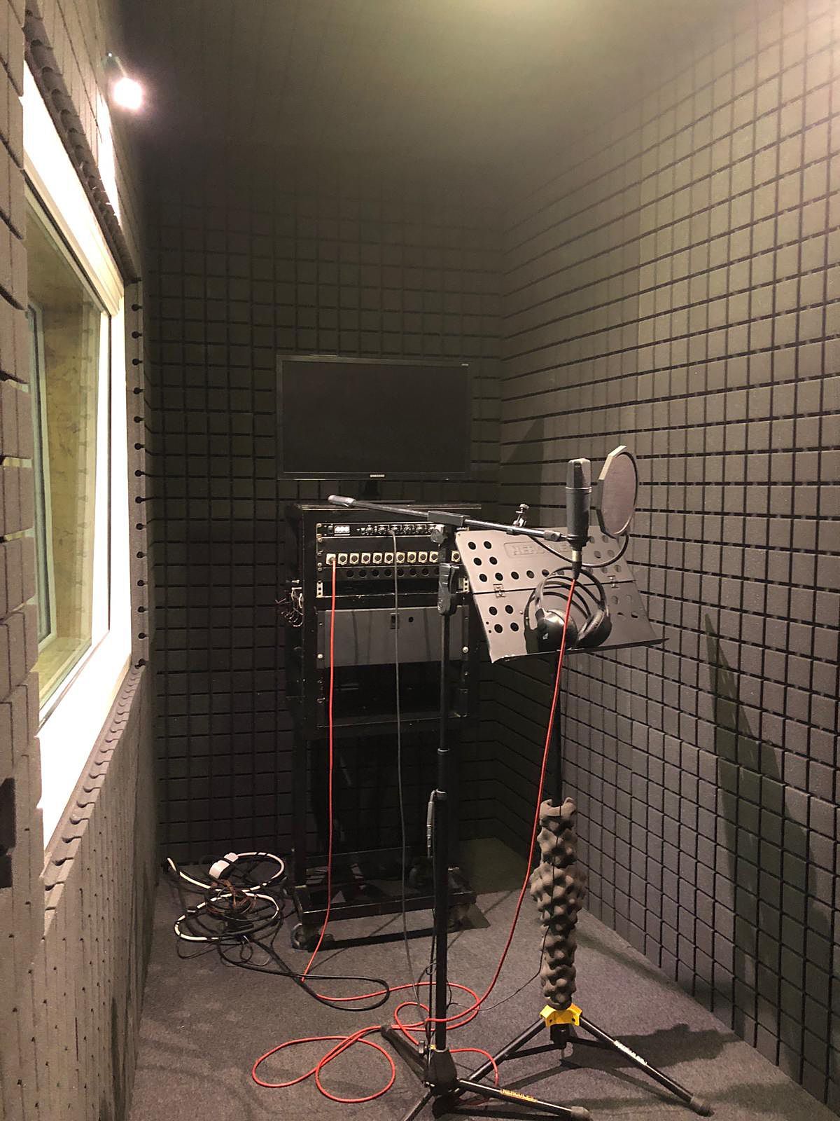 a recording studio with microphones and lights