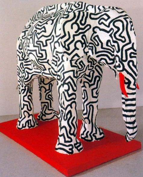 a sculpture of an elephant on a red platform