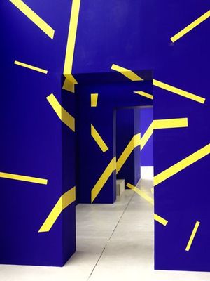 a blue room with yellow lines on the walls